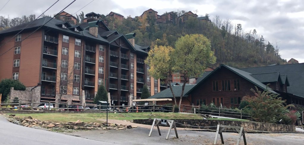 the exterior of the Westgate Smoky Mountain resort main building with condo buildings lining the mountain in the background