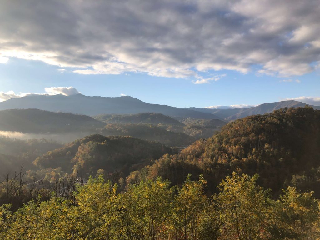 the Great Smoky Mountains in the morning, sun shining in and fog moving out