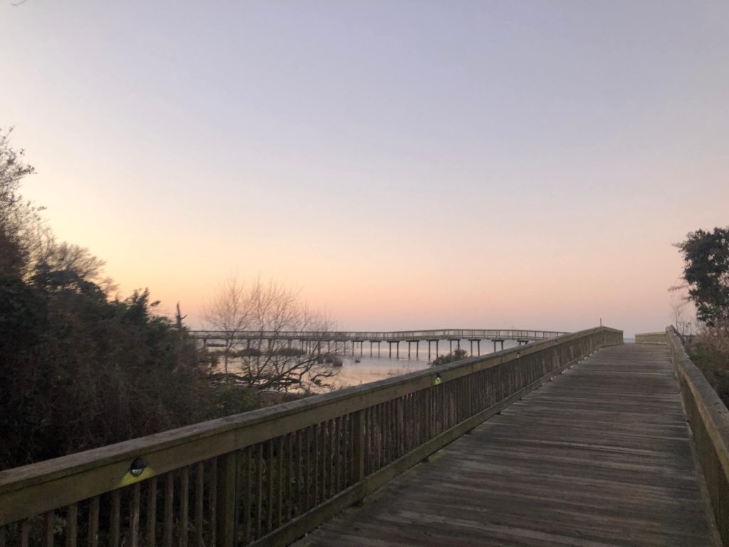 a long view of the boardwalk in Duck, North Carolina at sunrise