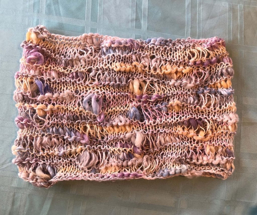 the Fairy Lights Cowl, a dropped stitch cowl knit in yarn of varying textures