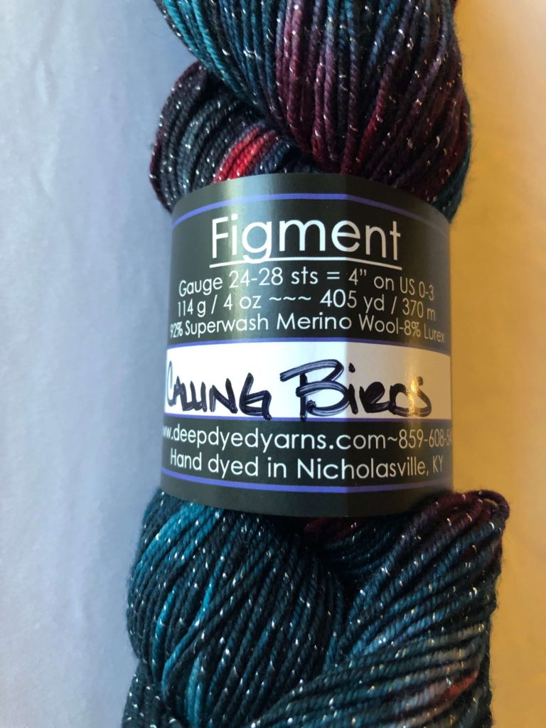 a close-up of the label for Figment yarn by Deep Dyed Yarns in colorway Calling Birds