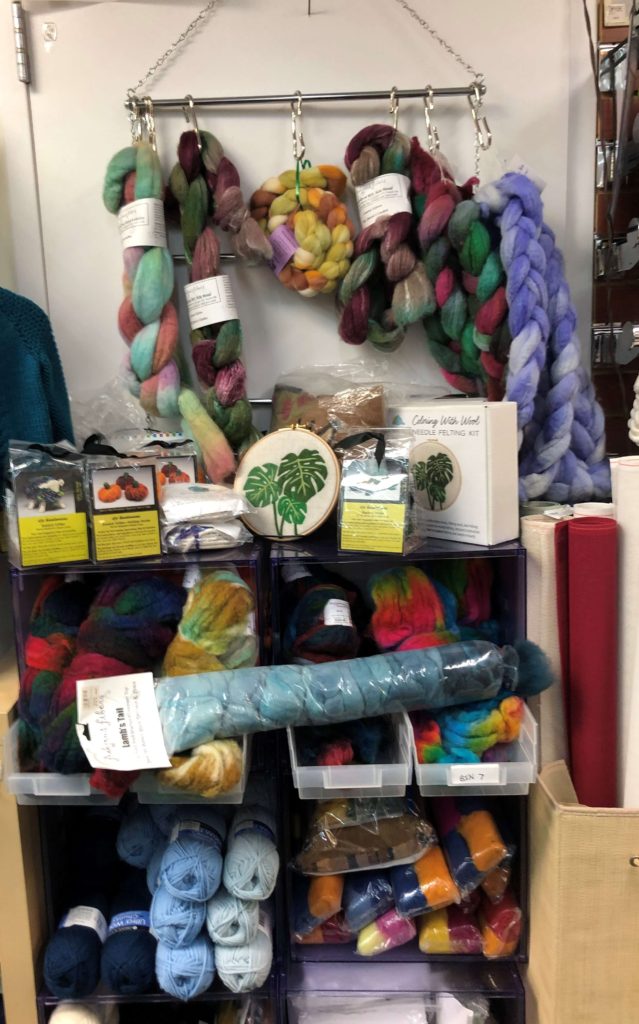braids of wool roving hang above felted wool kits