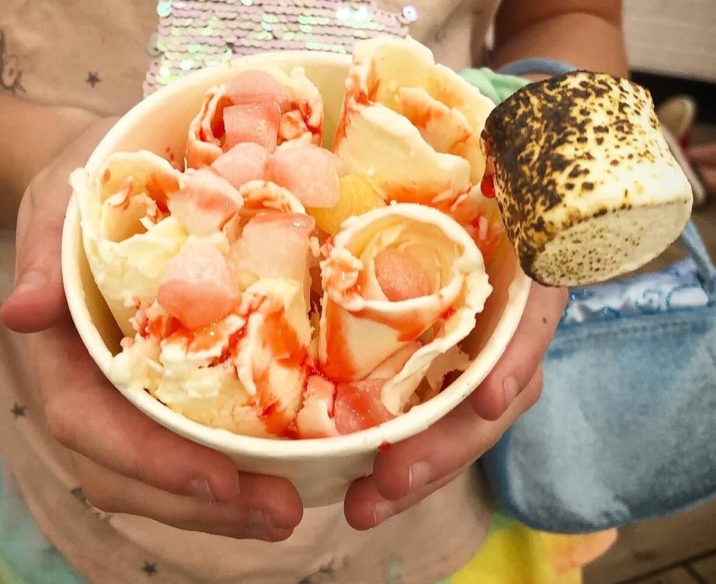 pineapple ice cream rolls with strawberry sauce, mini mochi, and a single toasted marshmallow