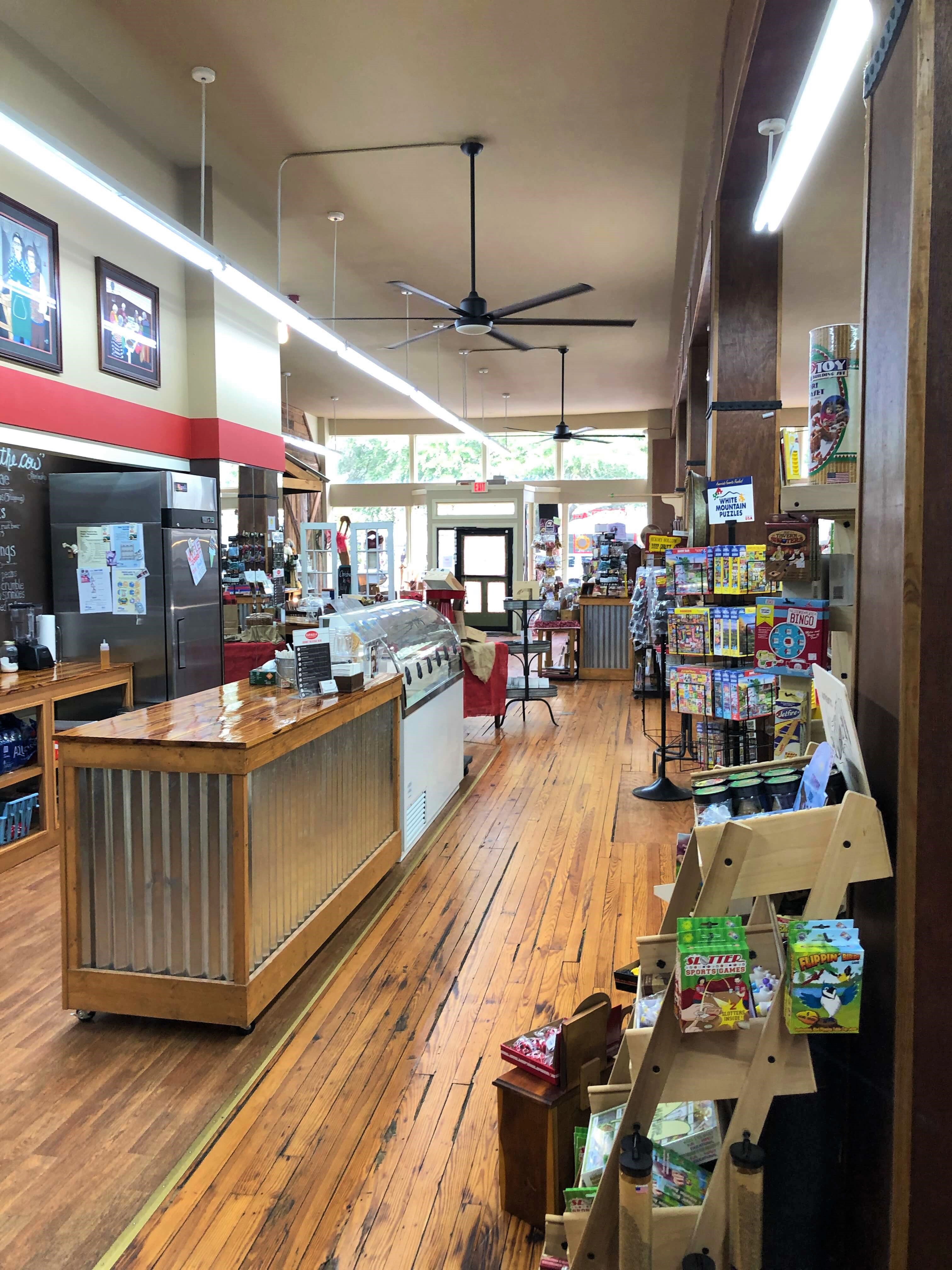 a long view of Superior Pecans & Gifts shows the ice cream counter and several candies