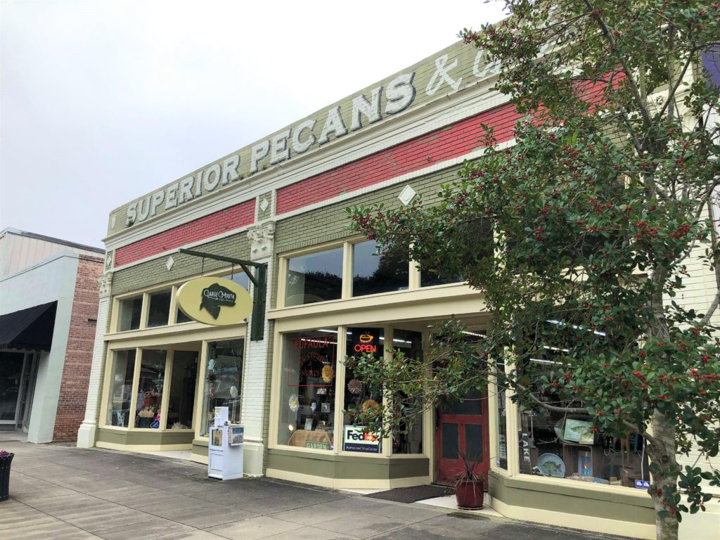 the Superior Pecans & Gifts storefront features a sign for the Large Mouth Coffee Co.