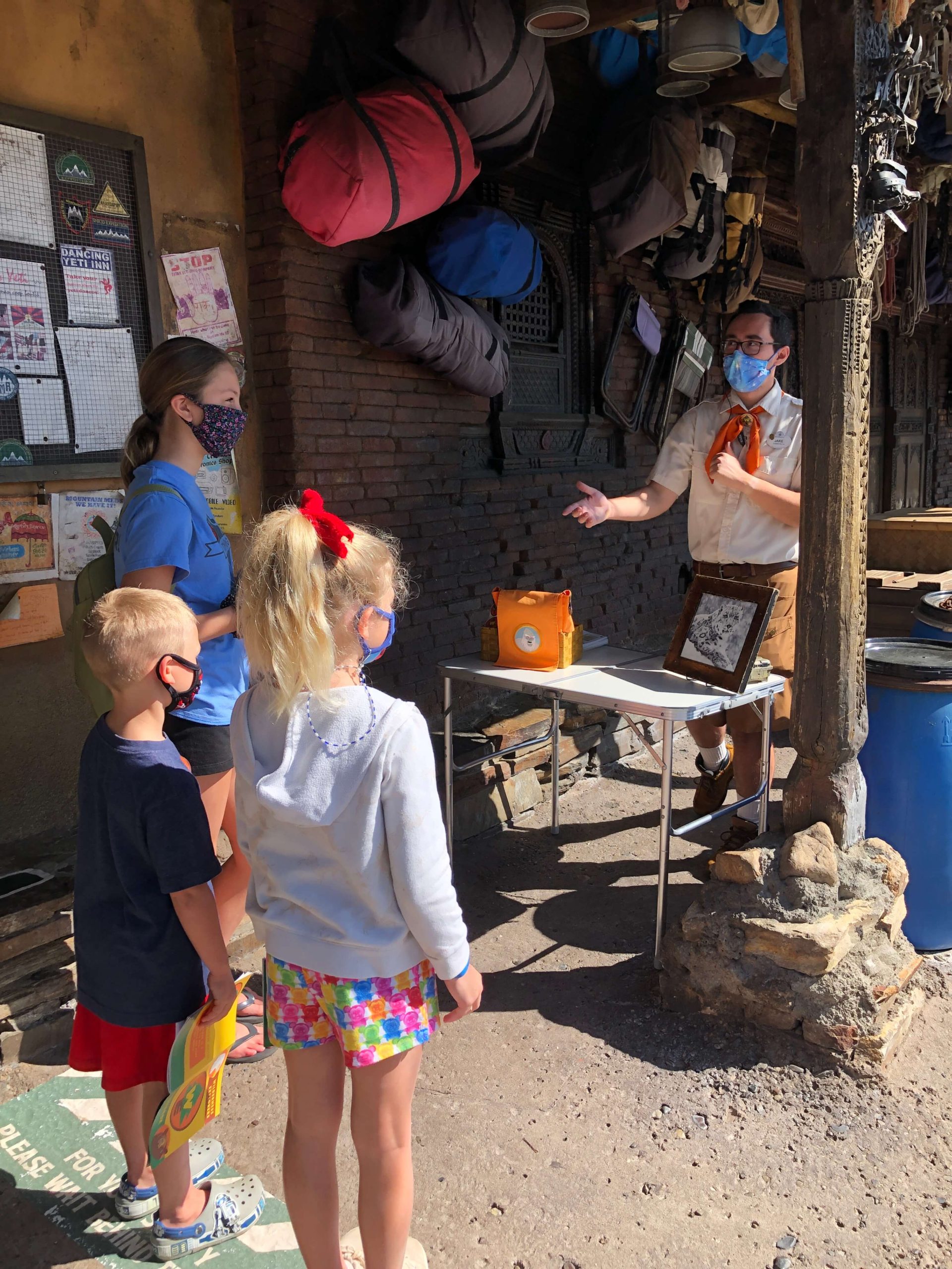 a Wilderness Explorer badge guide explains to three children how possible animals are called cryptids