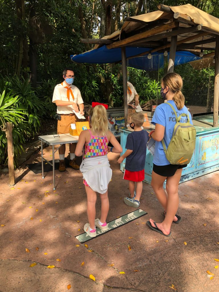 a Wilderness Explorer badge guide explains to three children how the Wilderness Explorer handbook works