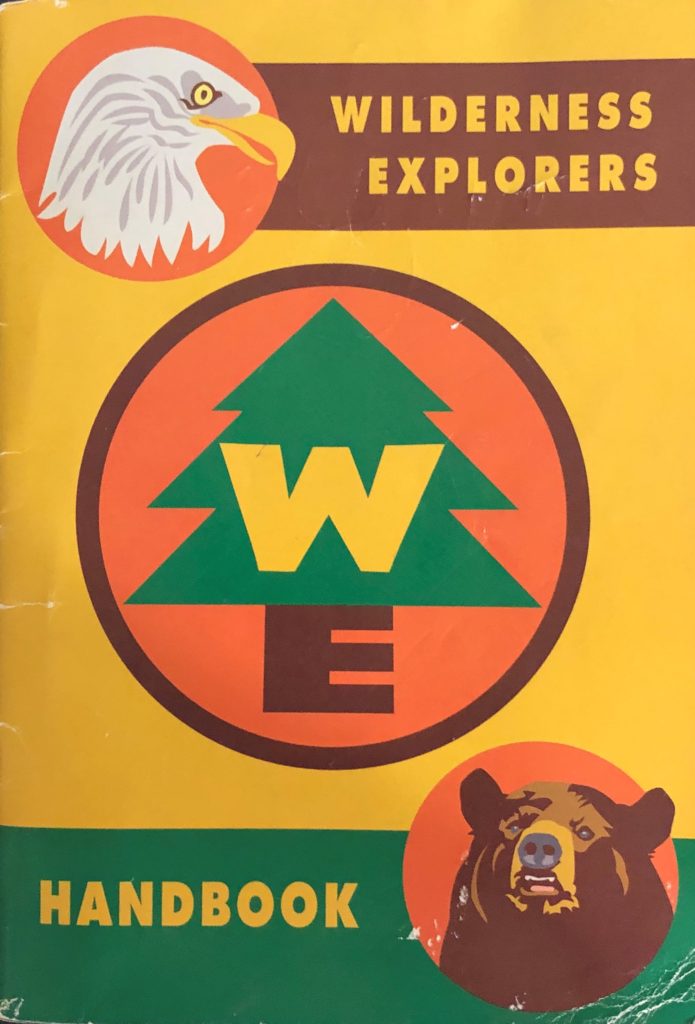 the cover of the Wilderness Explorers handbook with eagle and bear busts