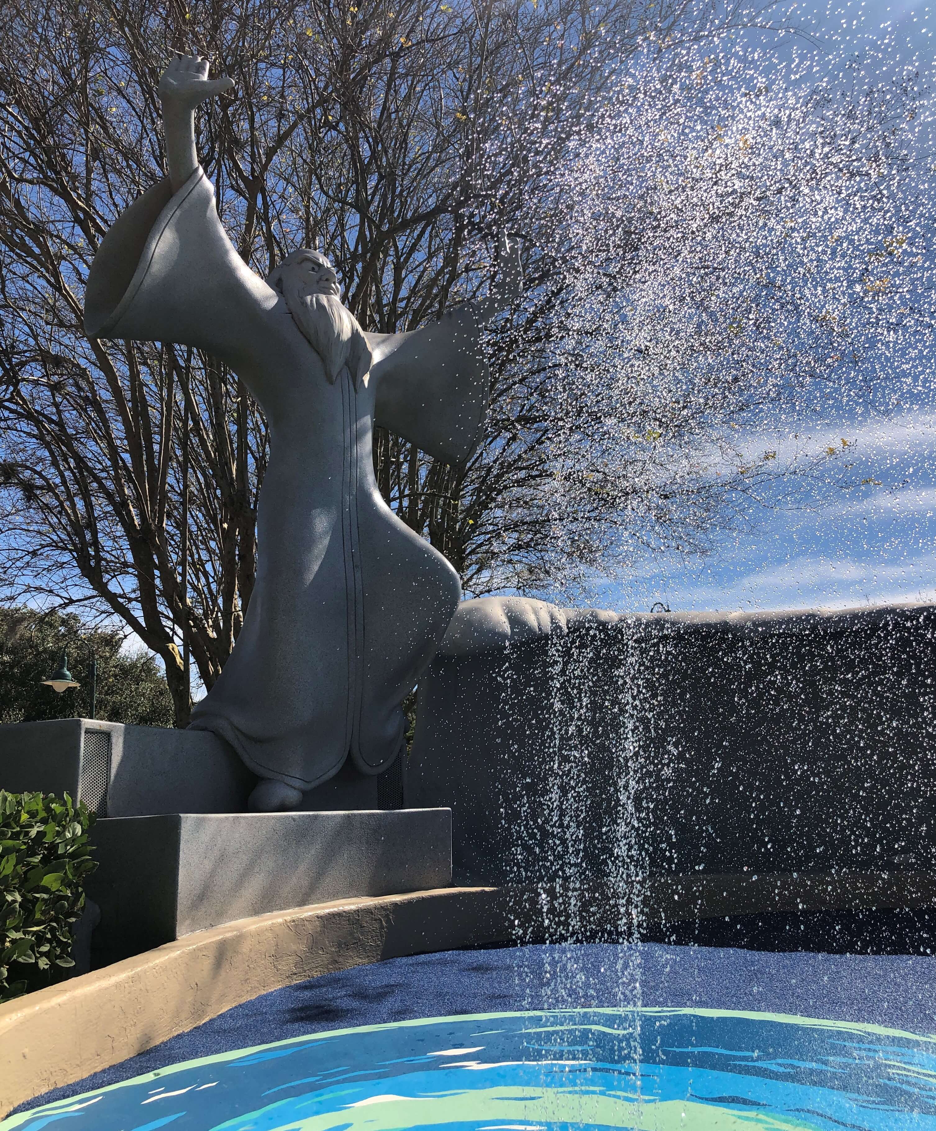 a geyser erupts in front of Yen Sid, the sorcerer who leaves his hat behind in Fantasia