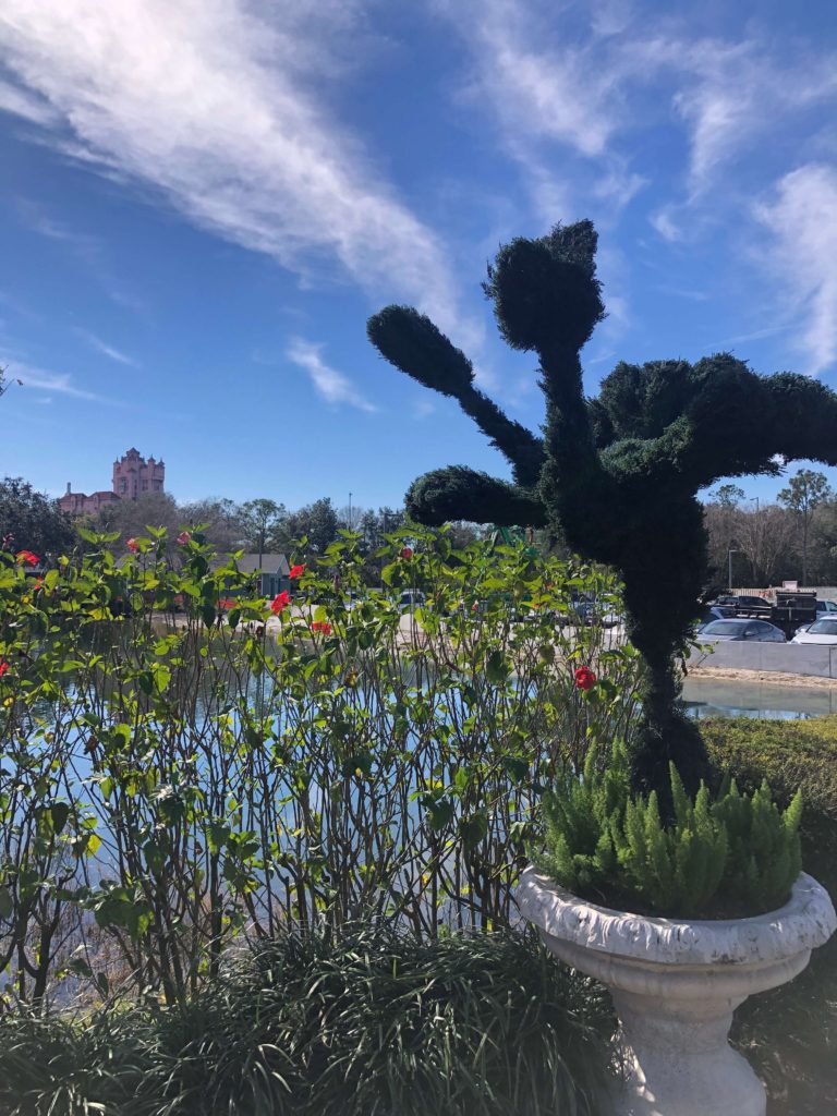 a dancing bird shrubbery spins in front of the Hollywood Tower Hotel