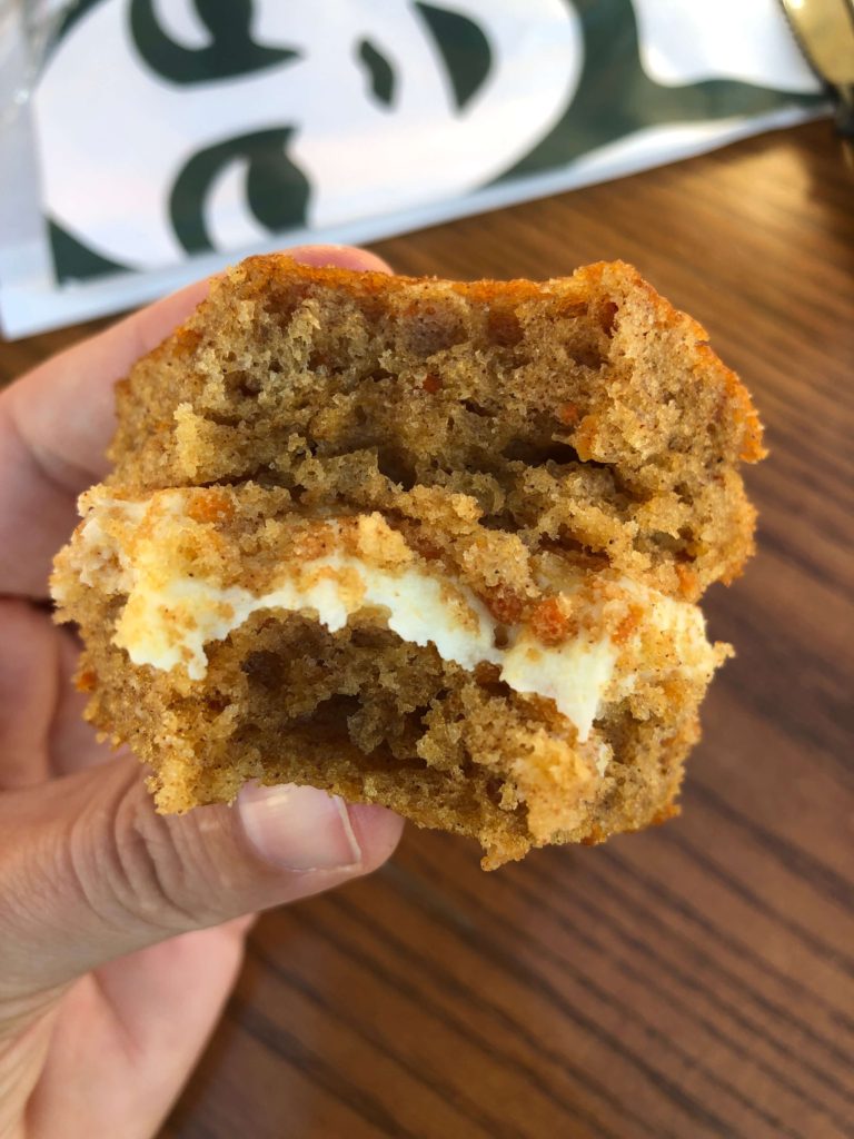 a close-up view of thick frosting between layers of spongy cake 