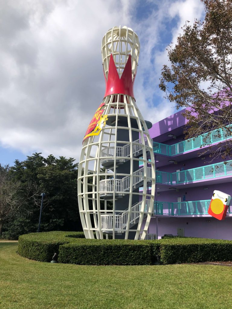 a sixty-foot bowling pin surrounds the stairwell of a building in the 1950s section of Disney's Pop Century Resort