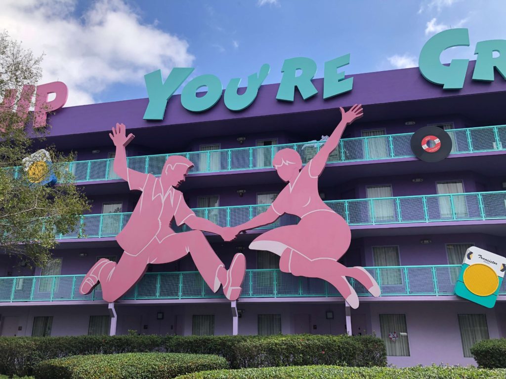 silhouettes of dancers that are three stories tall decorate a building in the 1950s section of Pop Century Resort