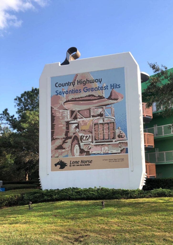 a four-story 8-track tape surrounding a stairwell reads "Country Highway Seventies Greatest Hits" and features a sketch of an 18-wheeler wearing a cowboy hat