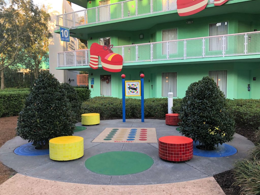 a landscaped area featuring a permanent Twister board on rubberized ground