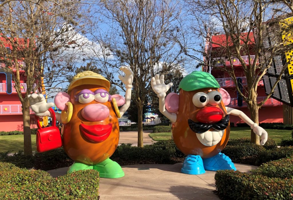 ten-foot-tall Mr. and Mrs. Potato Head statues in a garden