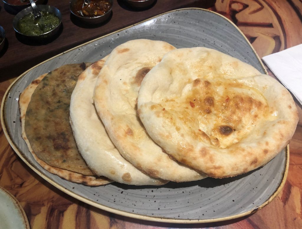 five different breads, including multiple versions of naan