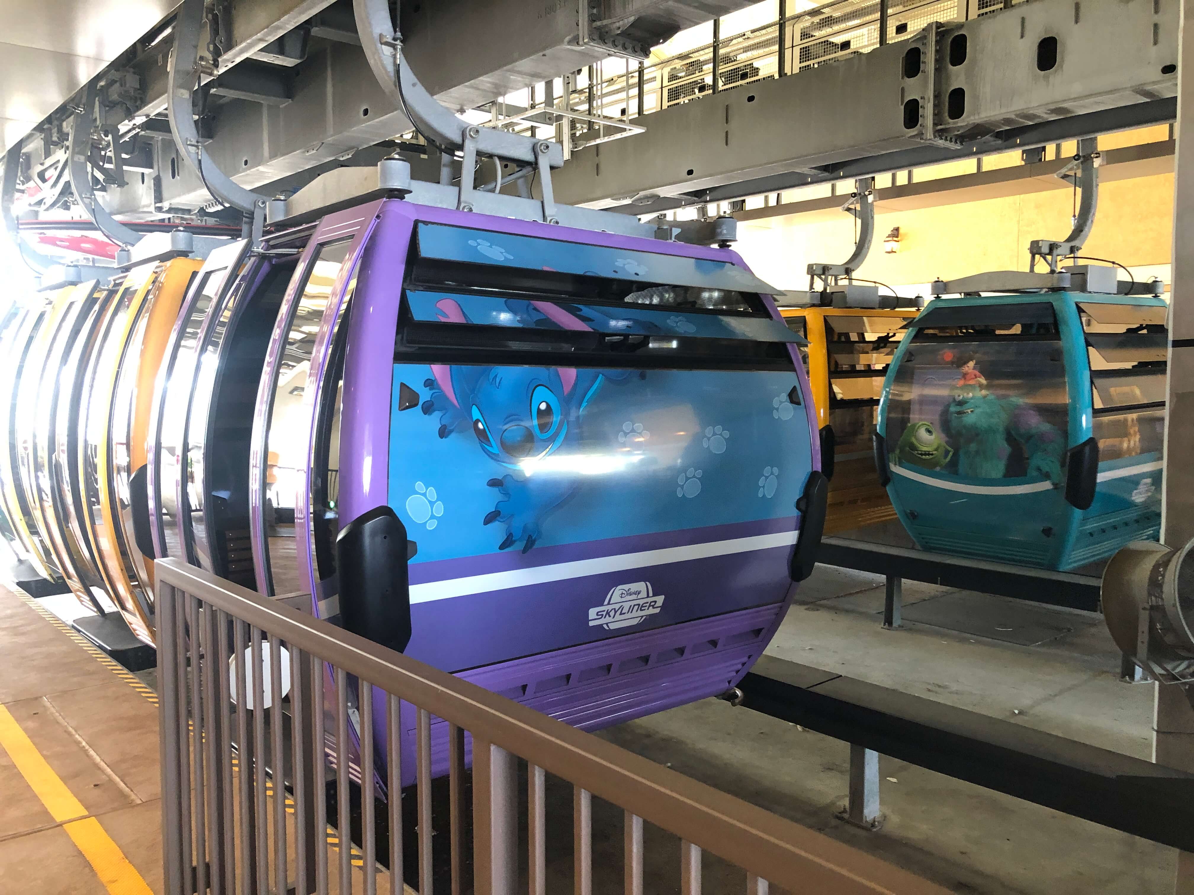 several gondolas hanging in queue for departure