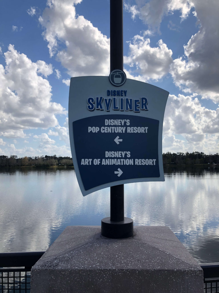 a sign points the way: Disney's Pop Century Resort to the left, Disney's Art of Animation Resort to the right