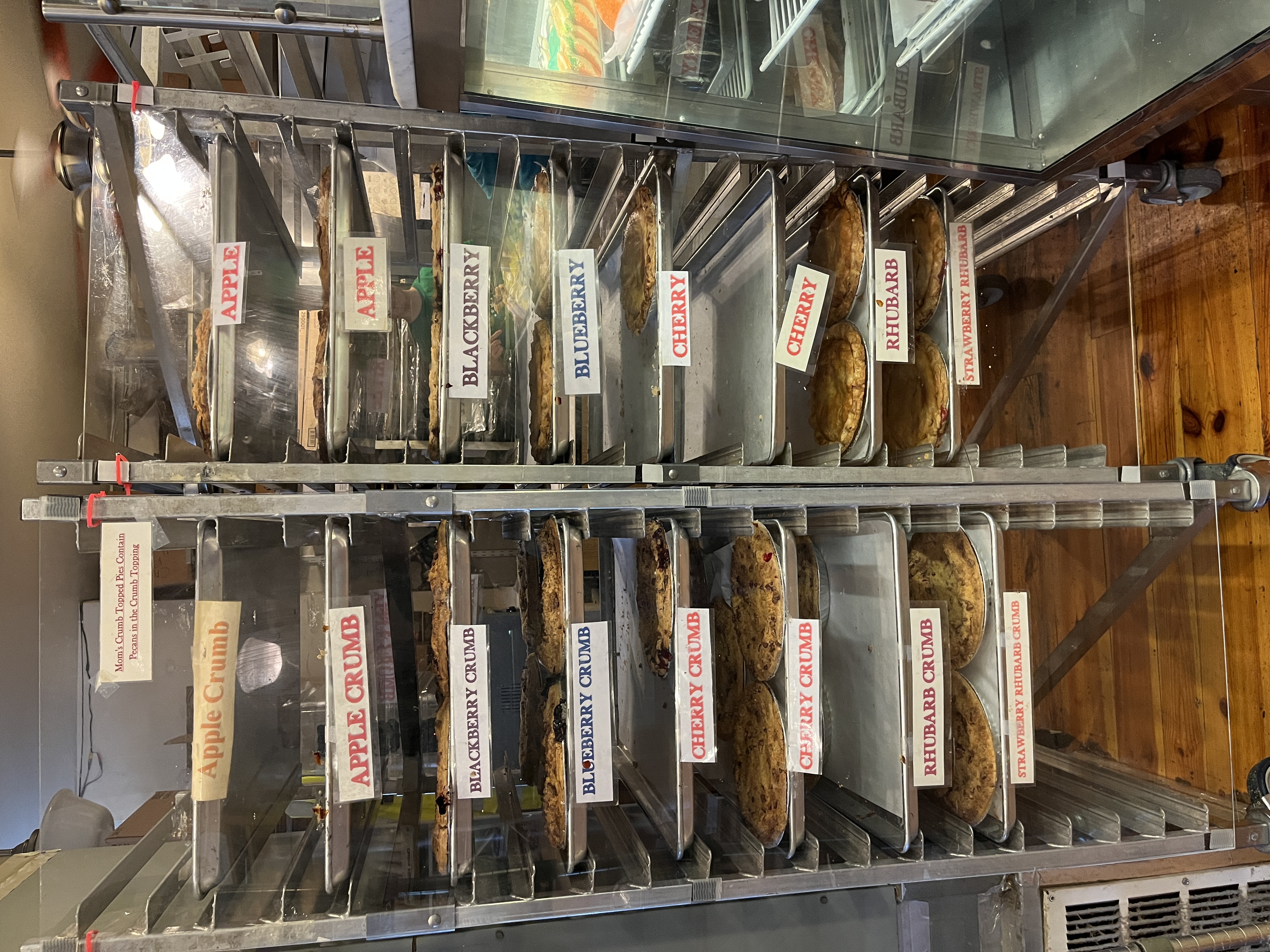 pies are stacked on cooling racks at Mom's Apple Pie Co.