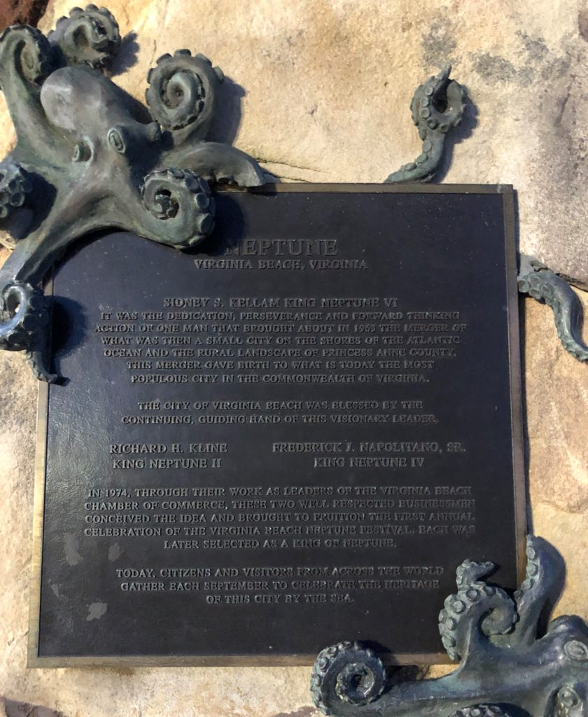 a plaque explains the provenance of the King Neptune Statue at the Virginia Beach Oceanfront