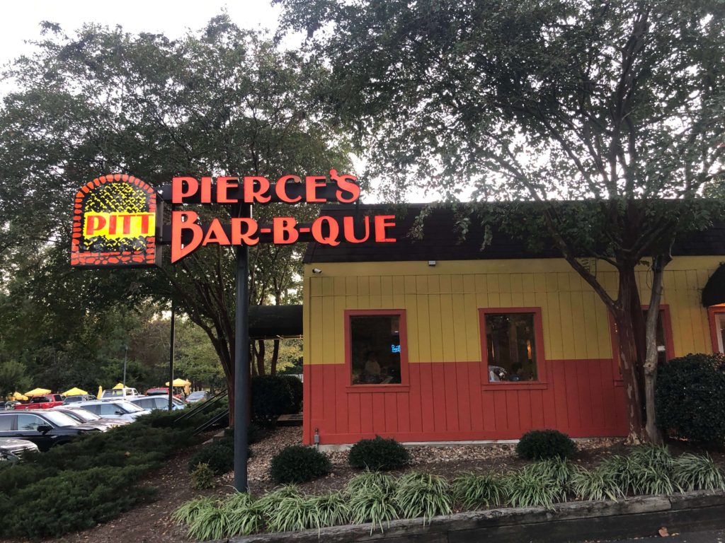 the exterior of Pierce's Pitt Bar-B-Que with the main sign lit up