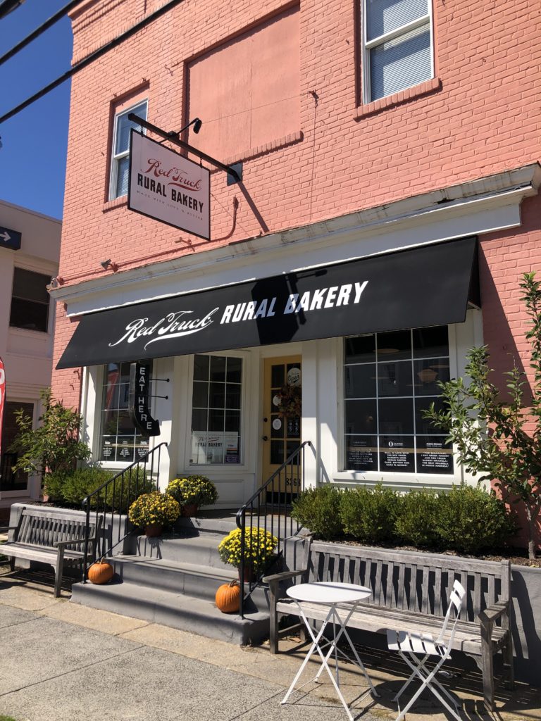 the storefront for the Red Truck Rural Bakery bears a sign that says EAT HERE