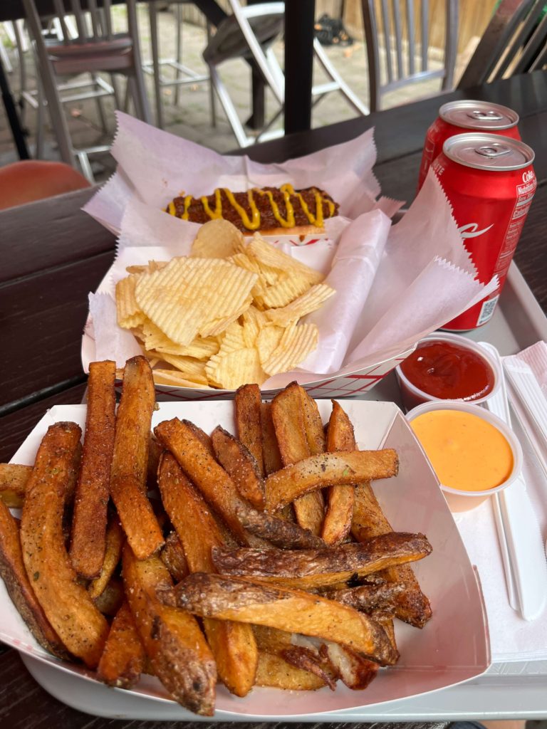 hand-cut fries seasoned with garlic with a side of spicy cheese sauce and ketchup