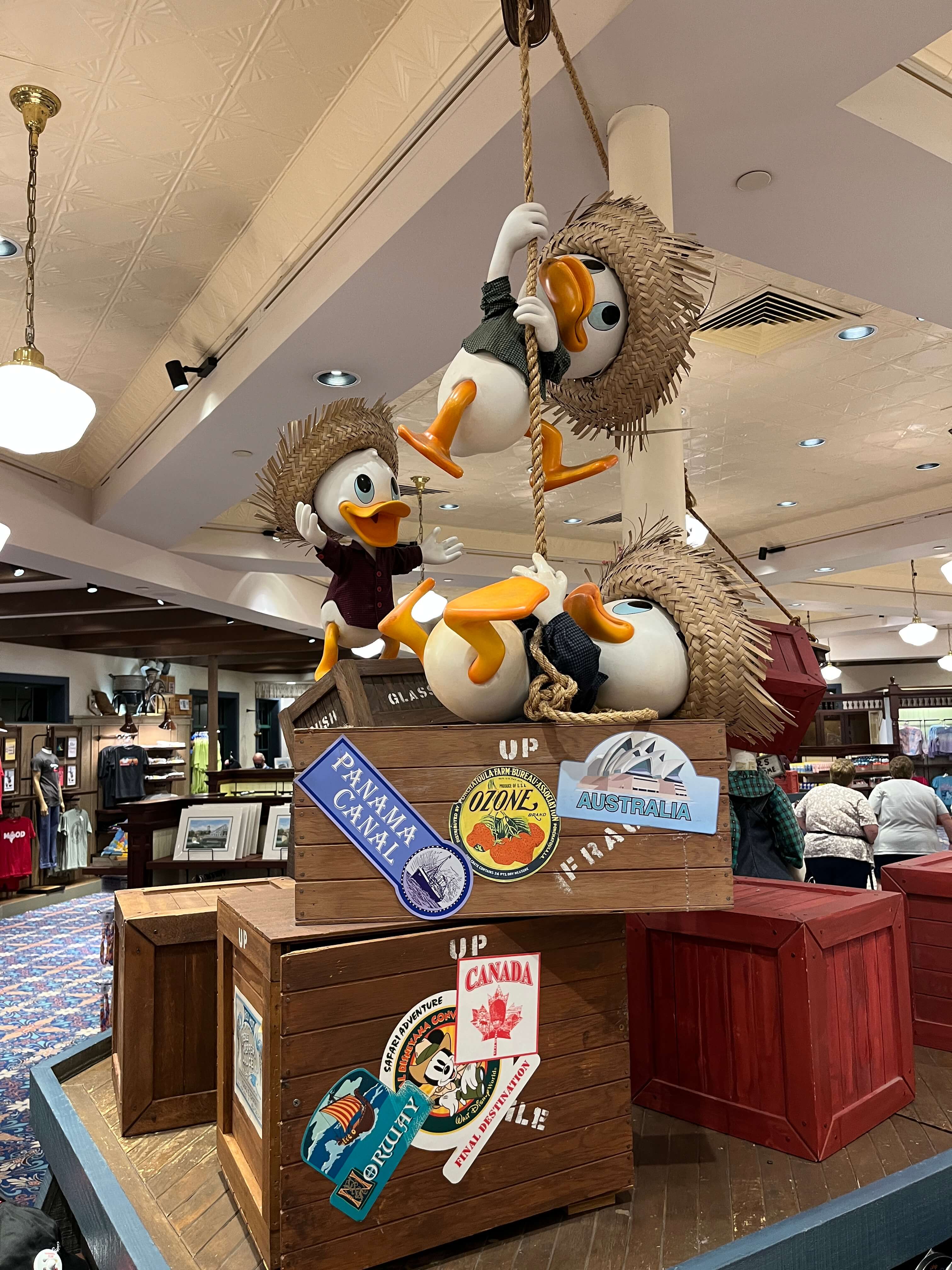 Huey, Dewey, and Louie hang from ropes and stand on piled crates at Fulton's General Store