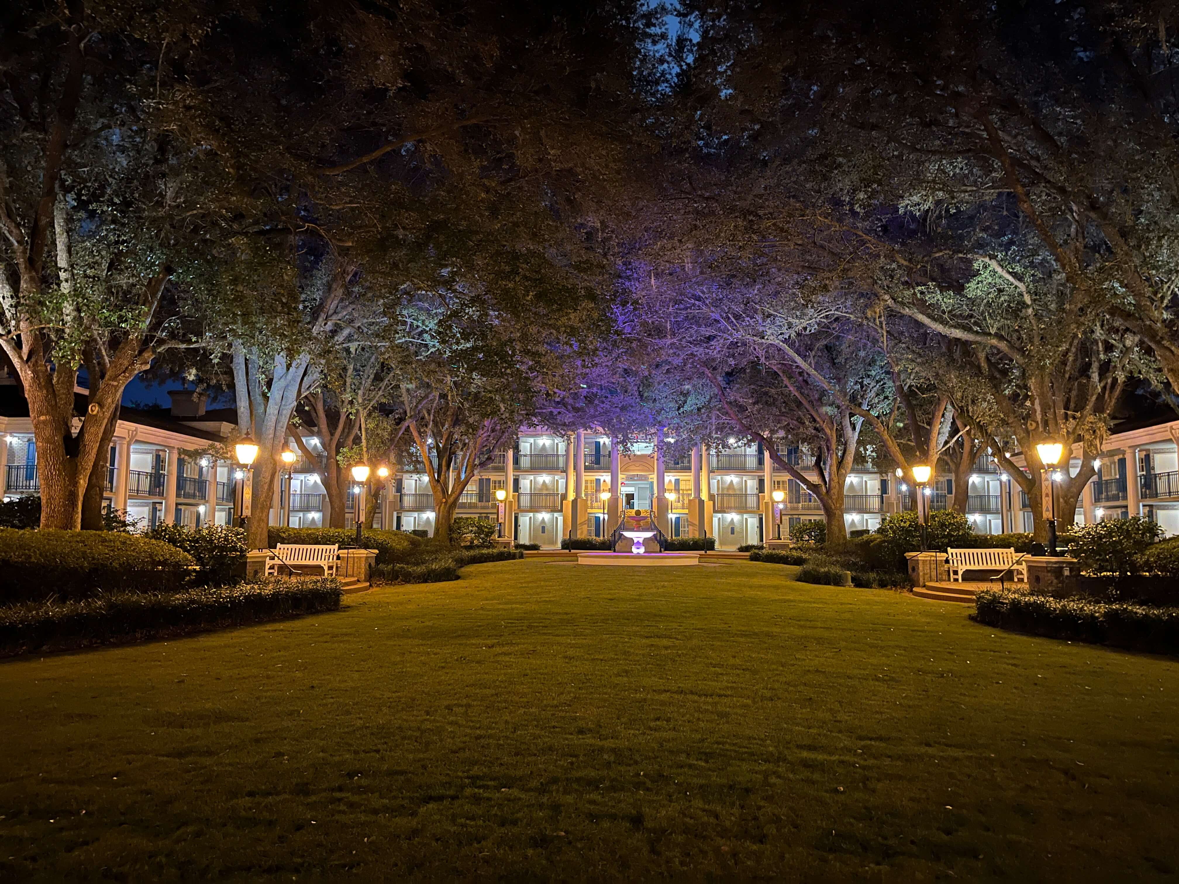 lights atop lamp posts illuminate a building in Magnolia Bend at Port Orleans Riverside