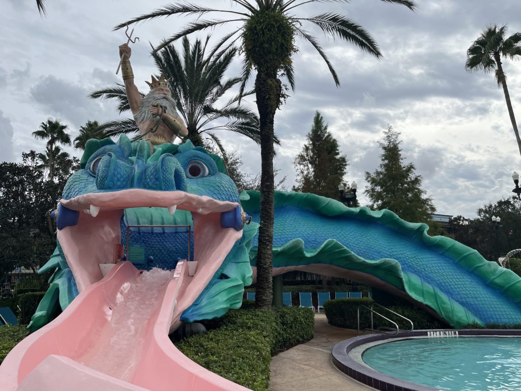 a water slide shaped like a giant serpent with Triton on his back
