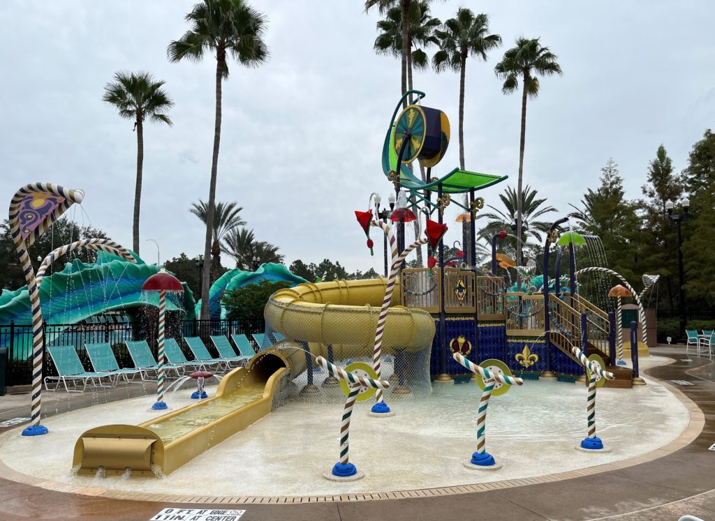 a large sprayground with slides, sprayers, and buckets