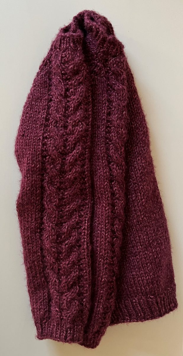 a knitted pullover, Flax sweater, with cables down the sleeves