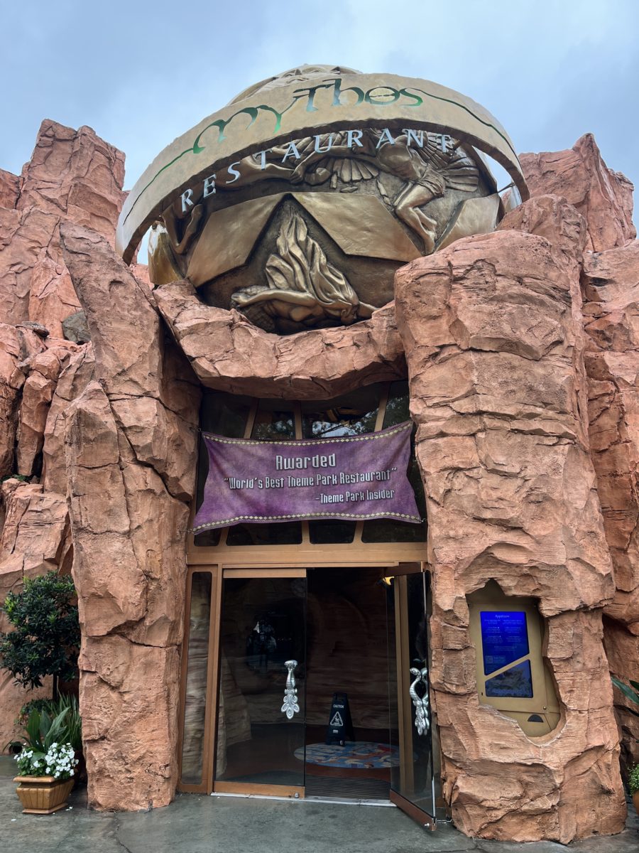 the exterior of Mythos Restaurant notes that it has been awarded "world's best theme park restaurant" by Theme Park Insider