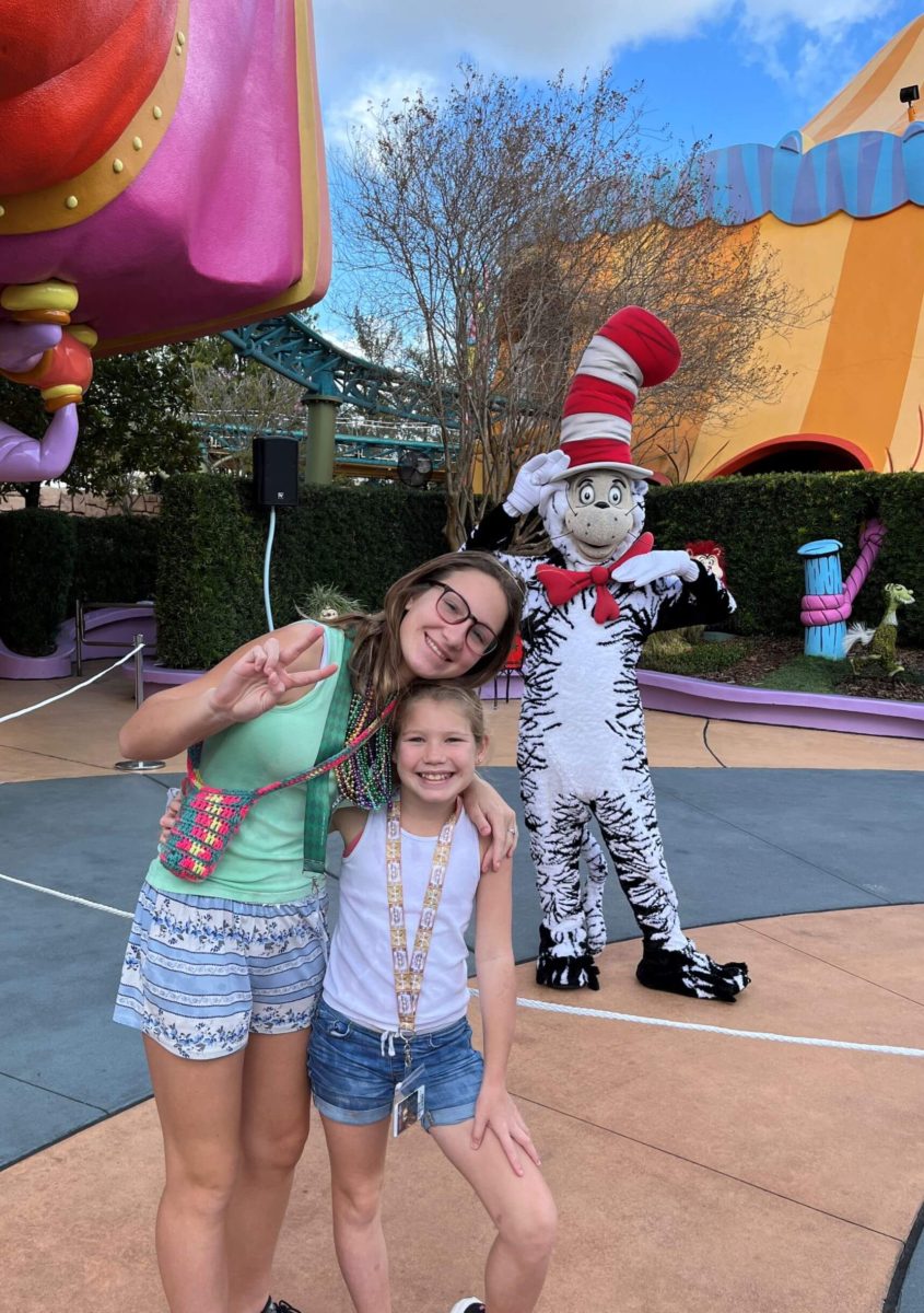two smiling children pose with the Cat in the Hat at Universal Orlando's Islands of Adventure