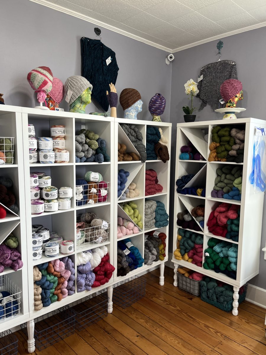 shelves stuffed with yarn and sample knits at Two Rivers yarns local yarn shop