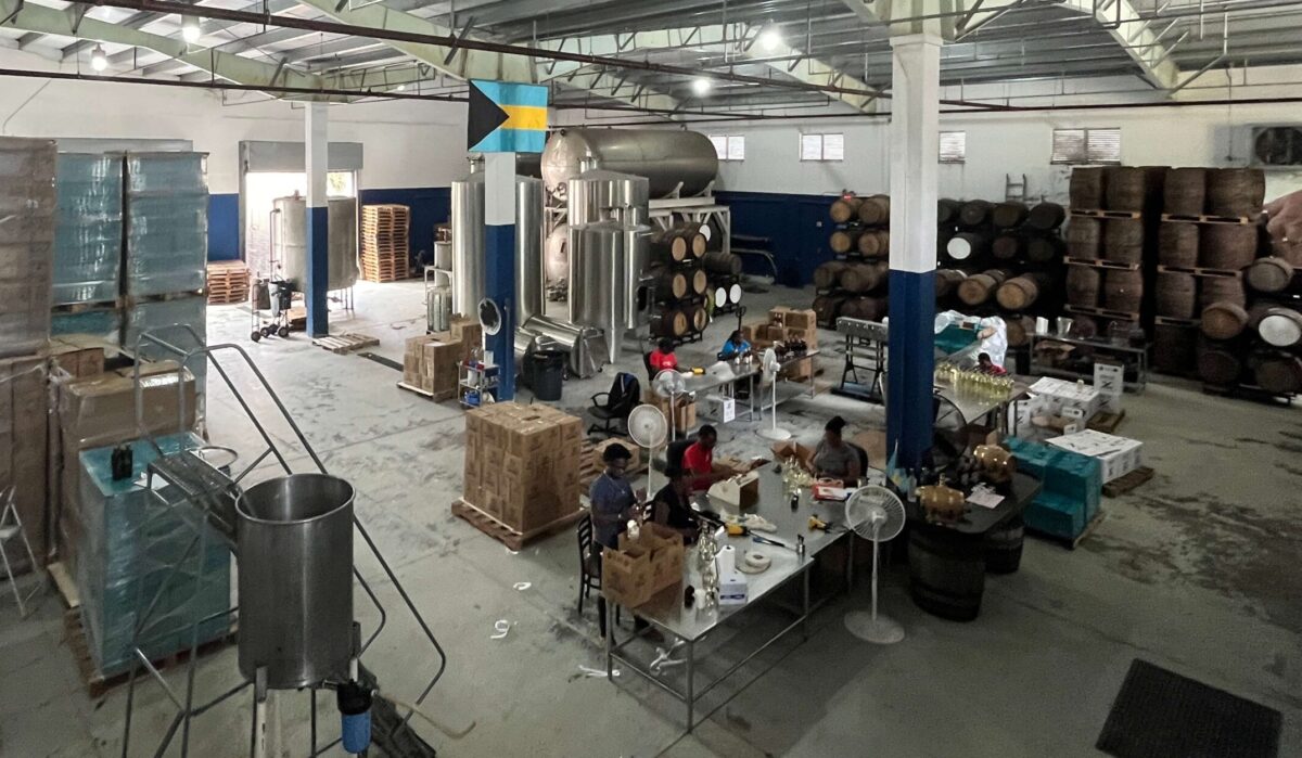 a large warehouse with employees working around a table